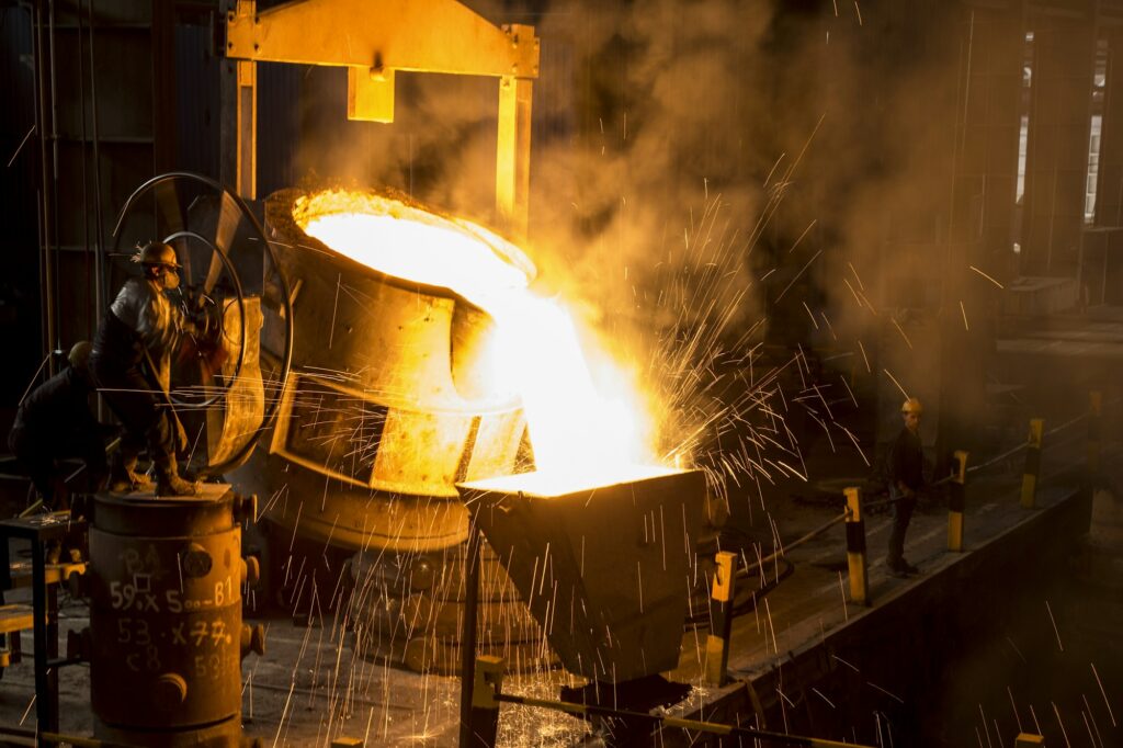 Molten steel poured from a ladle with a shower of sparks