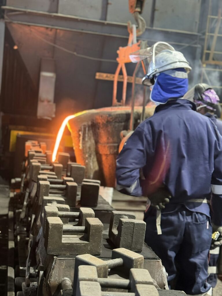 Steelworker overseeing molten metal in a foundry